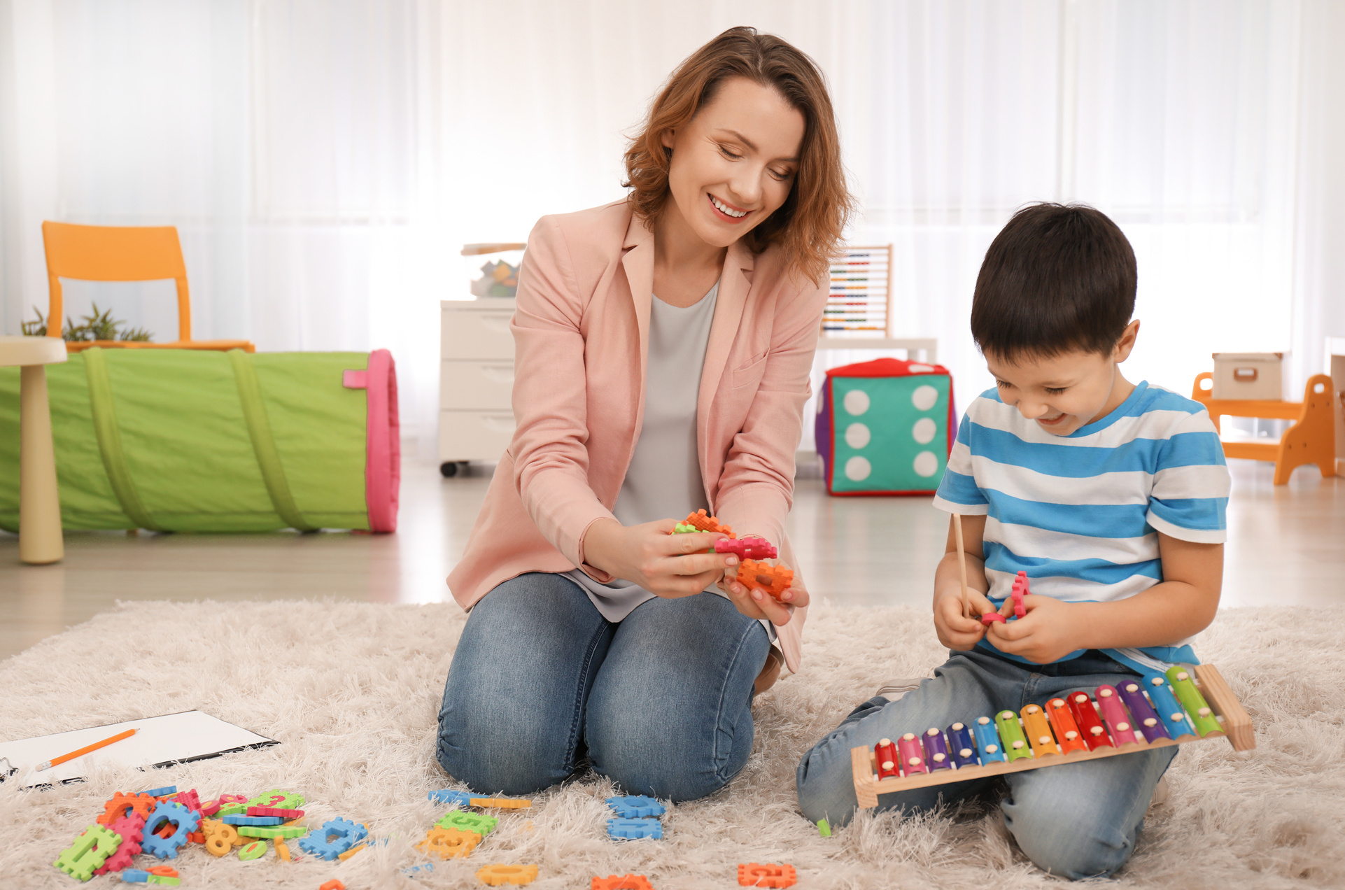 Female Psychologist Working with Boy Suffering from Autistic Disorder